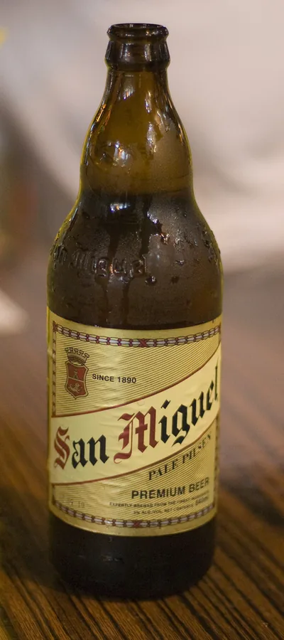 A standing bottle of San Miguel Pale Pilsen