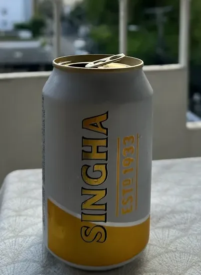 A standing Singha lager can